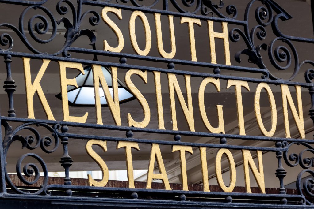 Metropolitan an district railways metal forging sign in London at the entrance South Kensington Station.