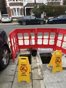 Clearing rat dragged debris from drainage system, South London